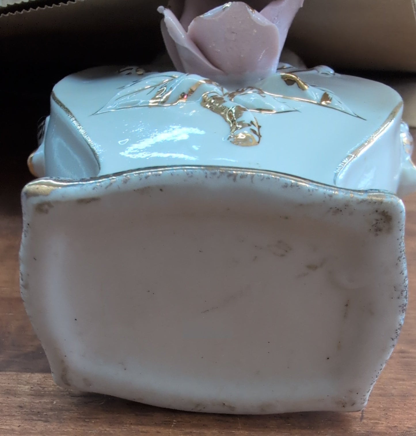 Japanese porcelain vase with raised rose and gold trim.