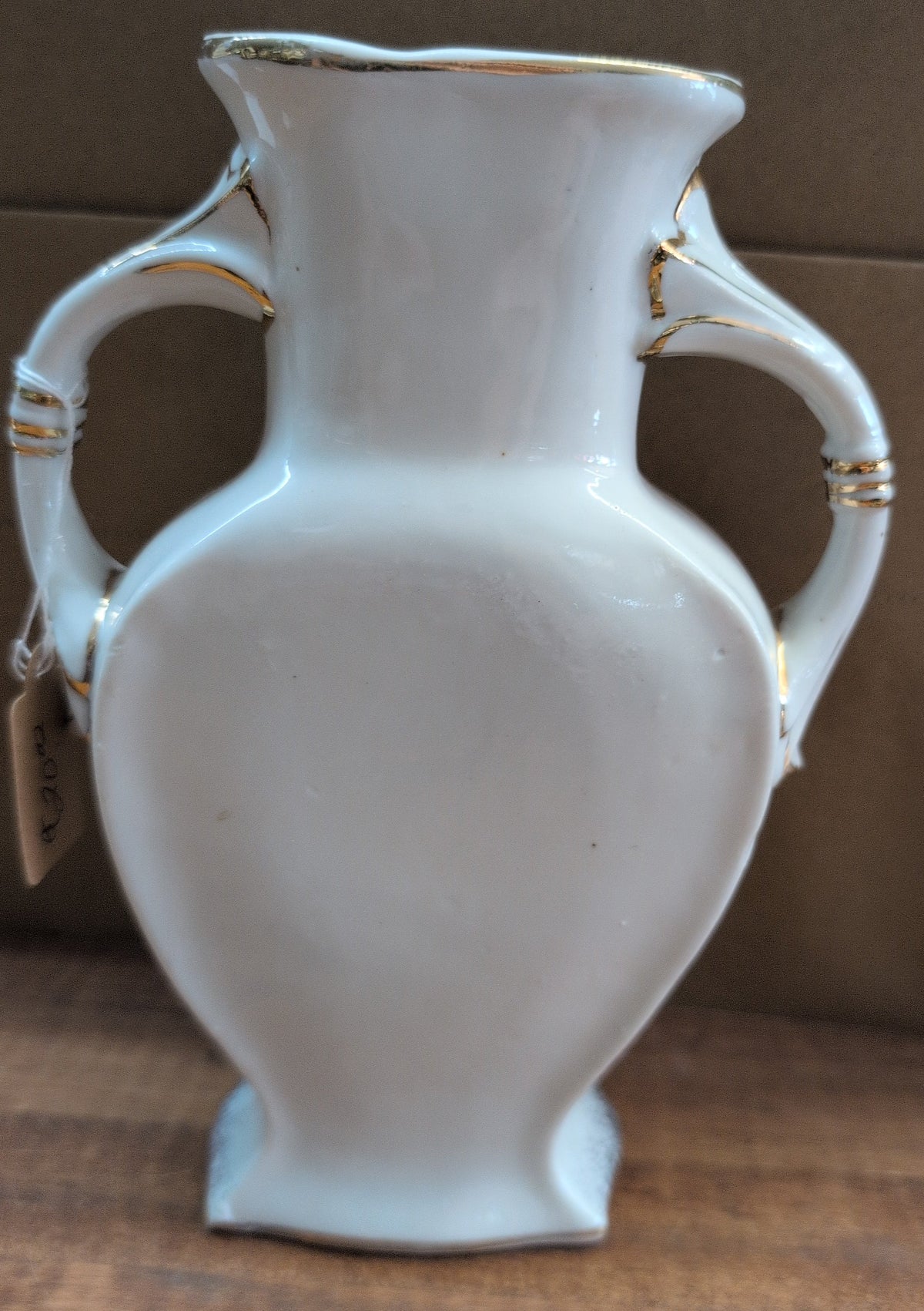 Japanese porcelain vase with raised rose and gold trim.